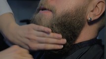Brushing beard in barbershop