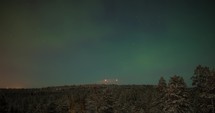 Timelapse of northern lights over the woods