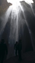 People Under A Waterfall In Iceland 