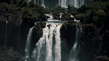 Waterfall Flowing Down Into River With Fog. Iguazu Falls In Parana, Brazil. tilt-down, slow motion