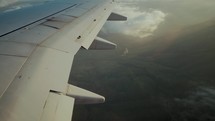 Airplane wing flying over ground