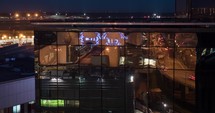 Timelapse of city reflecting in glassy building, night view