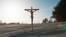 Crucifix In The Sand With Sunlight