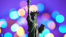 Statue of Liberty on the background of colorful twinkling bokeh