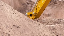 Slow motion excavator bucket shoveling dirt