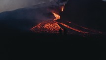Silhouette of people next to lava from Pacaya volcano eruption in Guatemala at night	