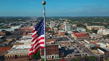 Waco, Texas Skyline and US Flag Panning Shot