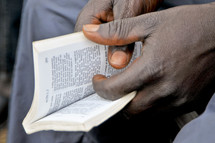 Hands holding a Bible.