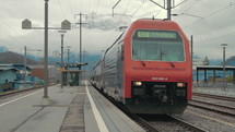 Train departs from railway station. Swiss – circa 2012.