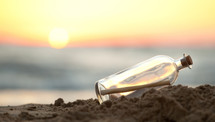 Message in a glass bottle on a beach with sunrise in background