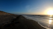 Sunset over the dirty beach of Langeoog island, Germany - handheld shot