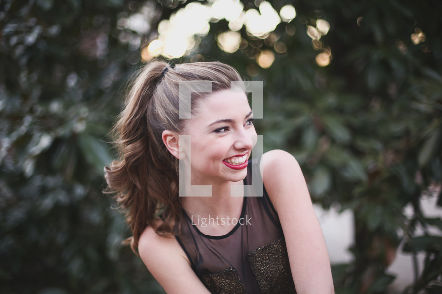 brunette teen girl with a pony tail smiling 