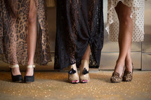 Women's legs, with fancy shoes on their feet.