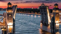 aerial view of a ship passing through a drawbridge at sunset in st petersburg 4k drone shot

