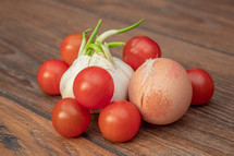 Cherry Tomatoes, Garlic and Egg on a Wooden Table