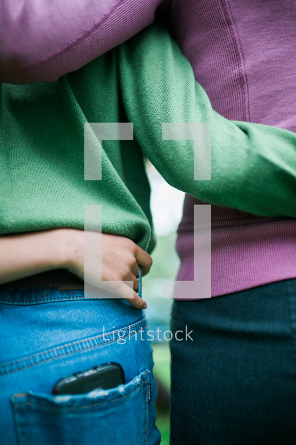women with arms around each other 
