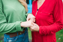 mother and daughter holding hands in prayer 