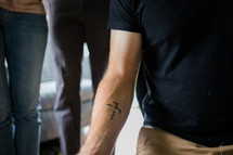 man with cross tattoo