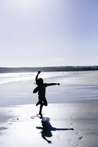 silhouette of a child playing on a beach 