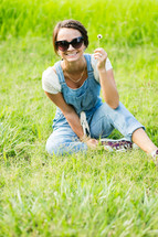 teen girl picking flowers in a field 
