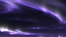 Purple Northern Lights in the night sky. Seamless loop	