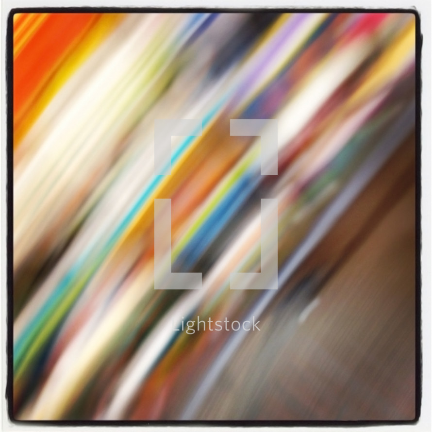 arcs of blurred color from spinning a camera, with a black on white border added