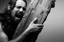 The suffering of Christ -- Jesus crying in pain while as he carries the cross.