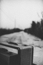 luggage on a dirt road