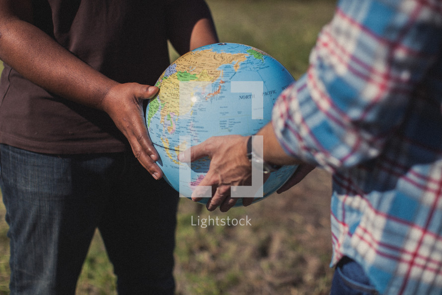 men holding a globe