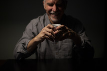 man drinking a cup of coffee 