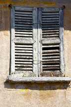 old wood shutters on a window in Italy 