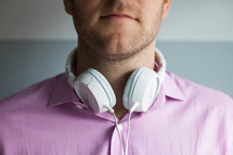 man with headphones around his neck 