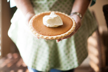 woman with a pumpkin pie 