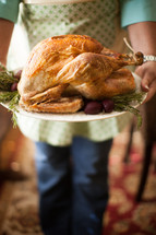 woman holding a Thanksgiving turkey 