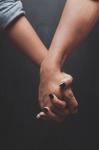 couple holding hands closeup 