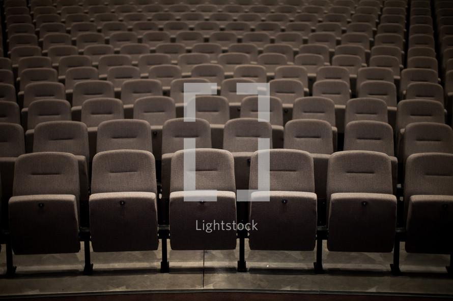 Rows of empty seats in an auditorium.