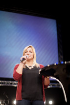 a woman with a microphone at the pulpit 