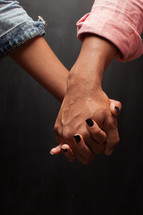 a man and woman holding hands 