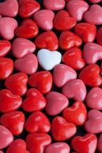 single white heart and red heart shaped candy 