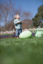 Oversized Easter egg  with young boy in the background