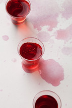 spilled red wine in communion cups 
