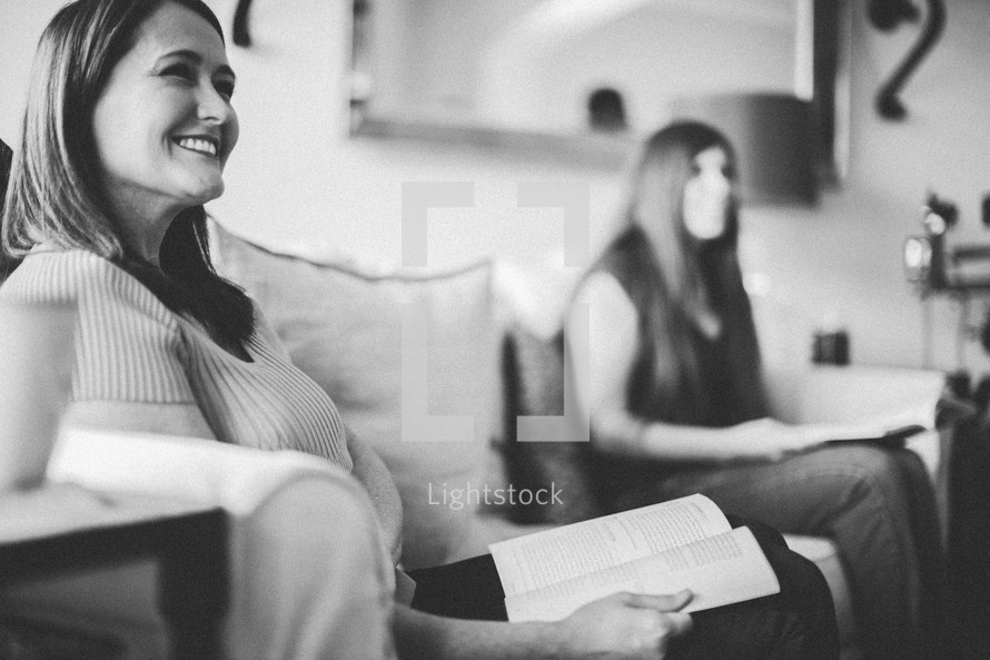 women at a Bible study sitting reading Bibles on a couch 