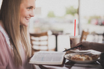 Smiling woman at a breakfast Bible study.