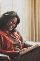 Joyful woman reading the Bible.