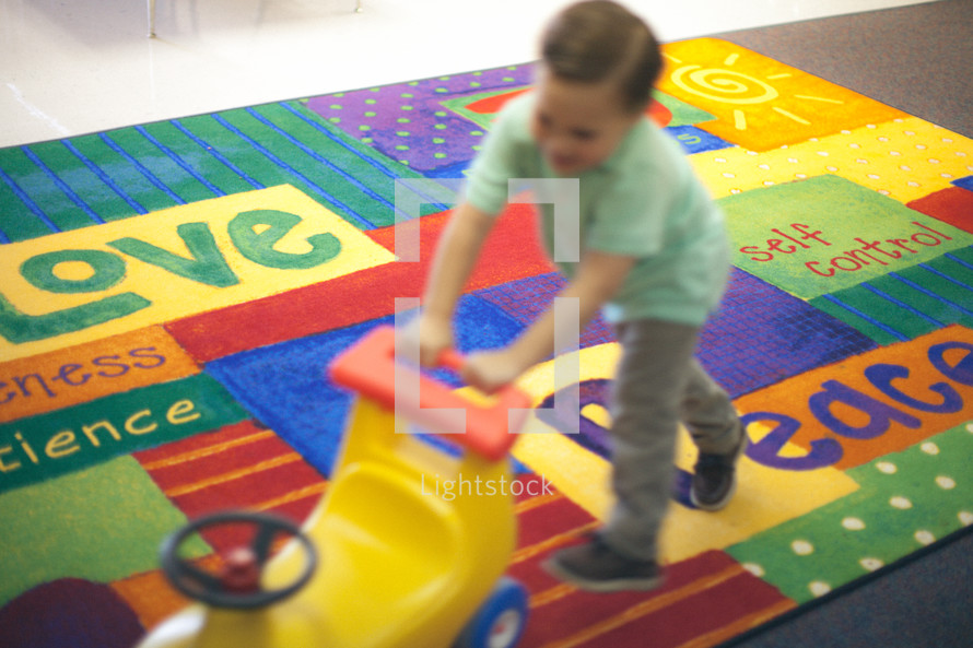 boy child playing with toys in a church nursery 