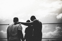 Silhouette of men in a huddle.