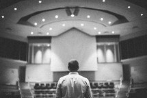 man standing at the altar in an empty church