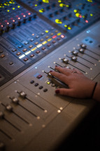 a hand on a sound board 