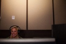 a woman with a headset on working sound production 