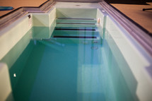 A baptismal tank filled with water.